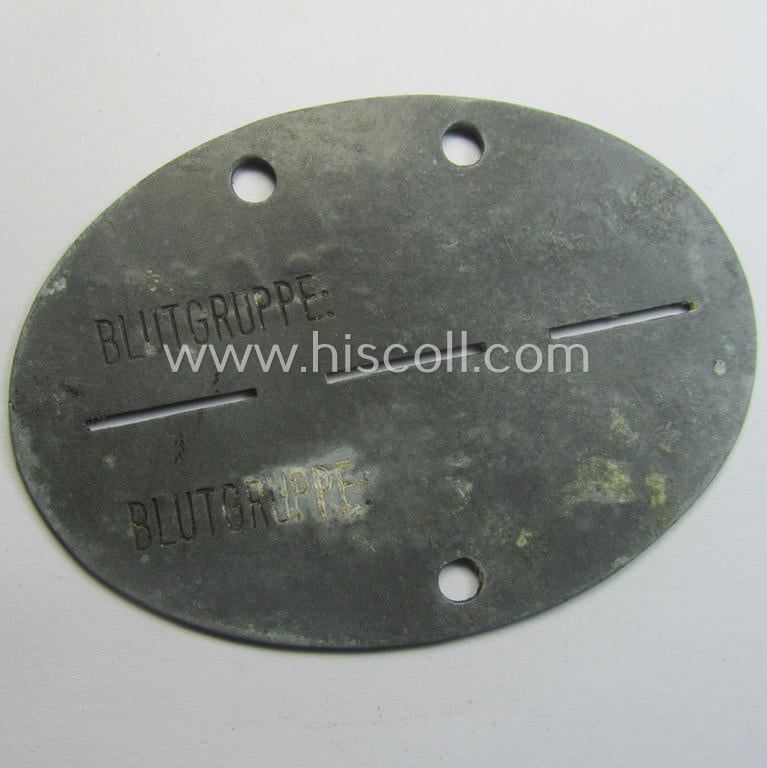 Zinc-based, WH (Heeres) 'Gebirgsjäger-Nachrichten'-related ID-disc bearing the clearly stamped unit-designation that reads: '6/Geb.Nach.Ers.Abt. 18' and that comes as issued and/or worn