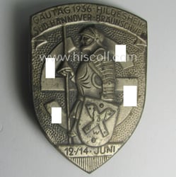 Silverish-coloured- and/or tin-based, N.S.D.A.P.-related day-badge (ie. 'tinnie' or:...