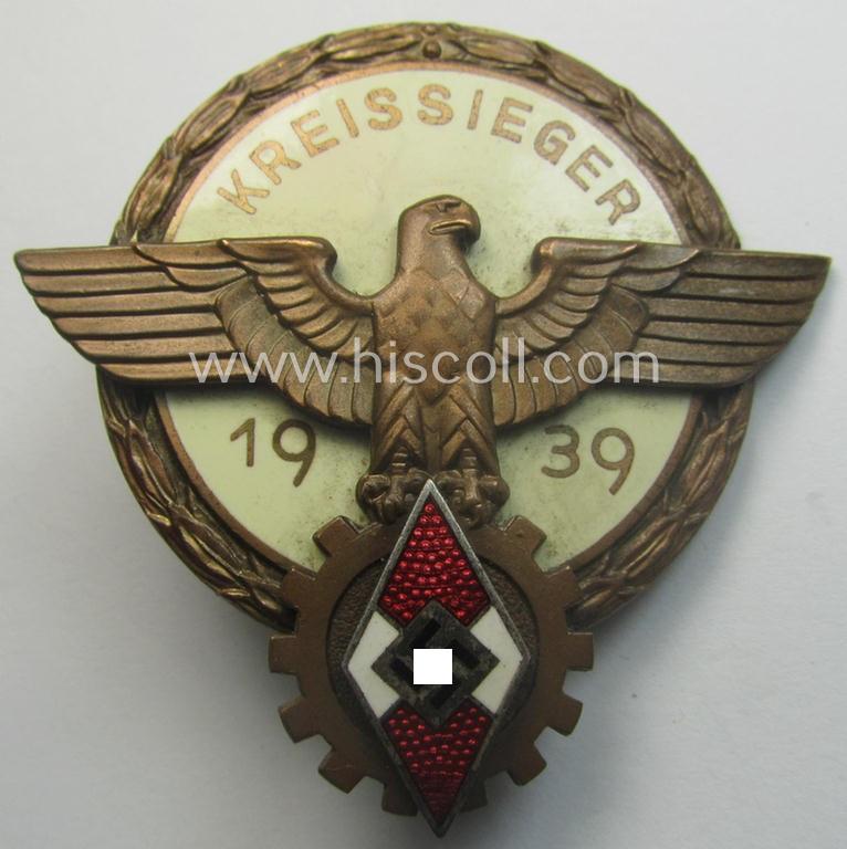 'HJ'- ('Hitlerjugend') ie. 'BDM'-related: 'Reichsberufswettkampf-Siegerabzeichen' (of the 2nd model) entitled: 'Kreissieger 1939' and being a maker- (ie.: 'Ferd. Wagner'-) marked example that comes with its period 'etui-inlay'