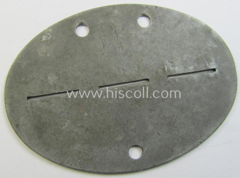 Attractive, zinc-based WH (Heeres) ie. 'Nachrichten'-related ID-disc (ie. 'Erkennungsmarke') bearing the clearly stamped unit-designation that reads: 'Nach.Ers.Battr. 186' and that comes as issued- and/or worn
