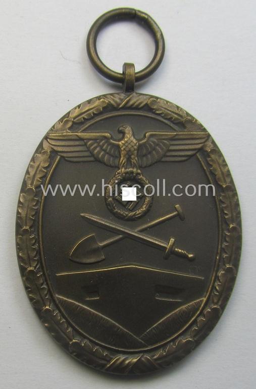 Medal-set: 'Deutsches Schutzwall Ehrenzeichen' (aka: 'Westwall'-medal) being a (typical) non-maker-marked- and/or: typical 'Buntmetall'-based specimen that comes packed in its original pouch of issue by the: 'Hermann Wernstein'-company