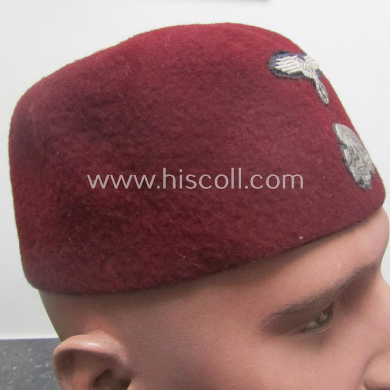 Maroon-red-coloured, Waffen-SS-pattern so-called: 'Fez' having a neat - and fully matching! - silver-grey-coloured- and/or 'BeVo'-woven insignia-set originally- (ie. 'off-factory'-) attached
