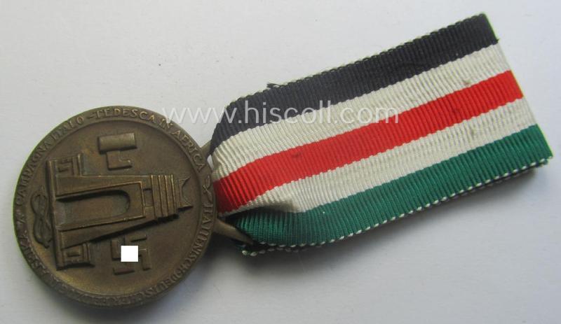 Golden-bronze-coloured (and 'Buntmetall'-based!) example of a: 'Deutsch-Italienische Feldzugsmedaille' (or: German-Italian campaign-medal) that came mounted onto its (full length- and 'virtually mint- ie. unissued') piece of original ribbon