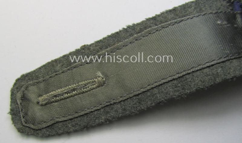 Single, later-war-period, so-called: 'M44'-pattern, simplified WH (Heeres) enlisted-mens'-type shoulderstrap as piped in the darker-blue-coloured branchcolour as was intended for usage by a: 'Soldat der Sanitäts-Truppen'