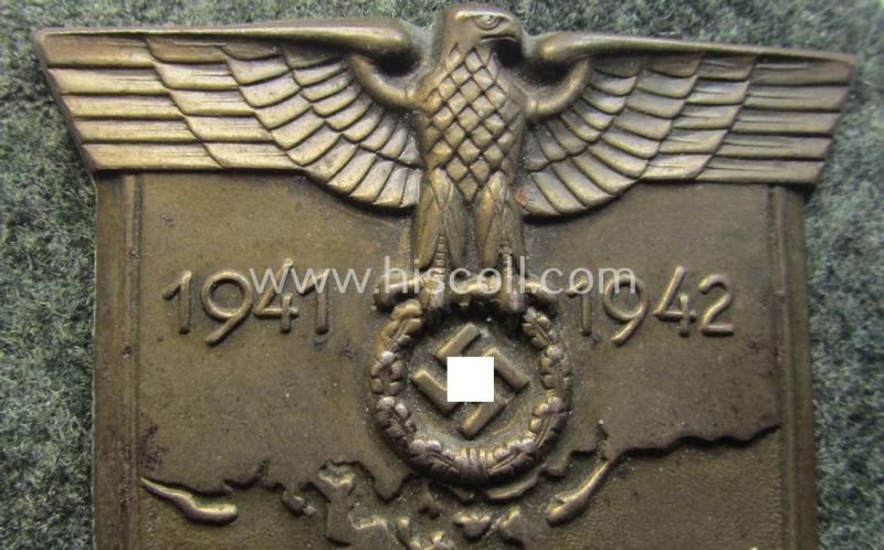 Attractive, WH (Heeres o. Waffen-SS) 'Krim'-campaign-shield that comes mounted onto its original, field-grey-coloured 'backing' and that comes in an issued-, minimally worn and/or (I deem) carefully tunic-removed-, condition