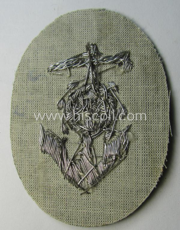 Superb, WH (Heeres) trade- and/or special-career insignia being a detailed- and/or neatly hand-embroidered example as executed on field-grey-coloured wool as was intended for a: 'Steuermann' (ie. enigineer-boat-pilot or helmsman)