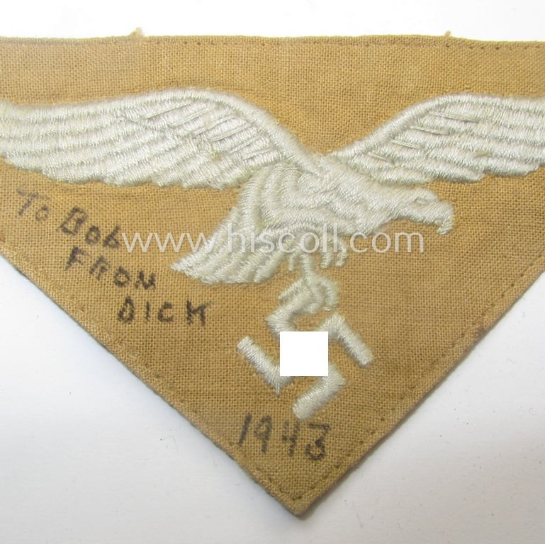 Truly used- and/or carefully shirt-removed, WH (Luftwaffe) 'tropical'-issued breasteagle as was intended for usage onto the tropical-shirts and that show a period ink-text of an US-soldier who liberated this piece as a 'war-souvenir'