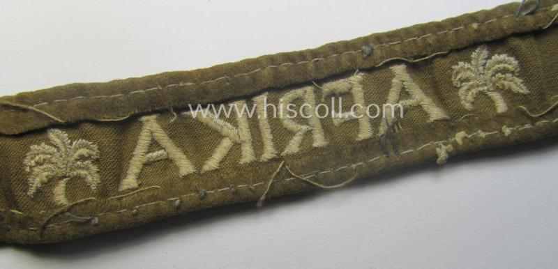 Neat, WH cuff-title (ie. 'Ärmelstreifen') entitled: 'Afrika' that comes in a clearly issued, worn- and/or most certainly once tunic-attached, condition