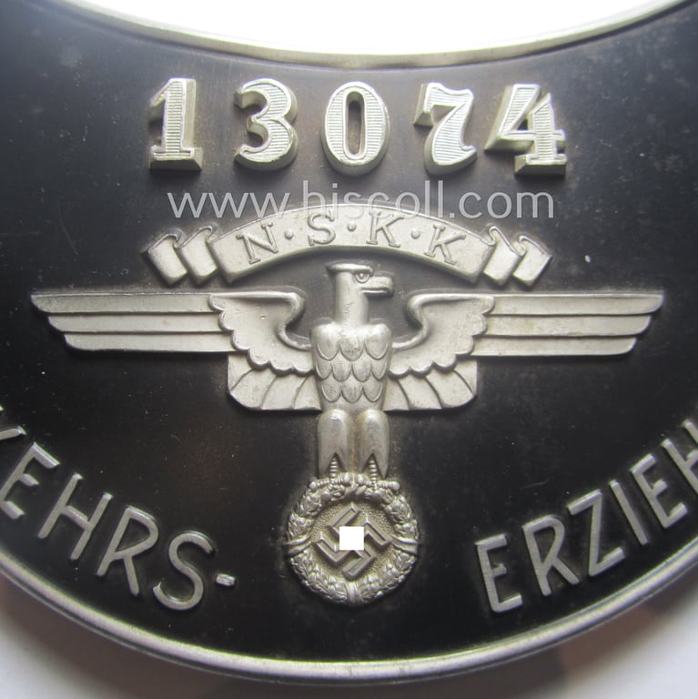 Superb - quite rarely seen and very detailed! - aluminium-based, N.S.K.K.-related gorget (ie. 'Brustschild o. Ringkragen') depicting the typical N.S.K.K.-eagle-device, unique numeral: '13074' and text that reads: 'N.S.K.K. Verkehrserziehungsdienst'