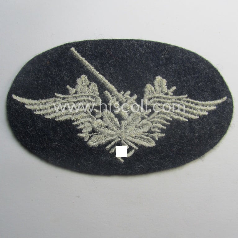 Machine-embroidered WH (Luftwaffe) trade- ie. special-career-patch as was intended for: 'Flak-Artillerie'-staffmembers and that comes in a probably issued but never worn- (ie. 'virtually mint'-), condition