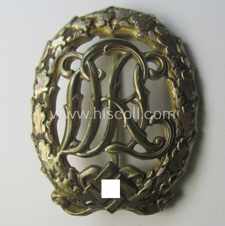 'Reichssportabzeichen DRL in Silber' (or: silver-class DRL sports'-badge) being a maker- (ie. 'Wernstein - Jena'-) marked example and that comes with its accompanying miniature