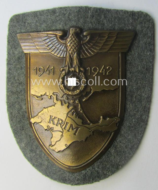 WH (Heeres ie. Waffen-SS) 'Krim'-campaign-shield (by the maker: 'Friedrich Orth') that comes stored in its period (and rarely seen!) 'Zellstoff'-based pouch and that comes in a probably issued- (albeit still 'virtually mint'-), condition