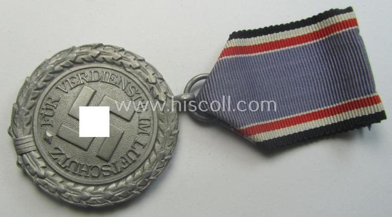 Light-weight (ie. typical aluminium-based) medal as was intended for air-raid wardens 2nd. class (or: 'Luftschutz-Ehrenzeichen 2. Stufe') that comes stored in its period, dove-grey-coloured etui
