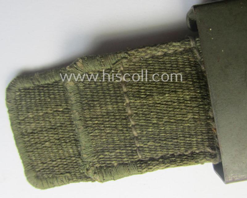 WH (Heeres) 'tropical-issued' belt-buckle being a clearly maker- (ie. 'HA'-) marked (and/or: '42'-dated) field-grey-coloured example that comes mounted onto its original, greenish-coloured- (and/or: 'webbing'-based-) tab