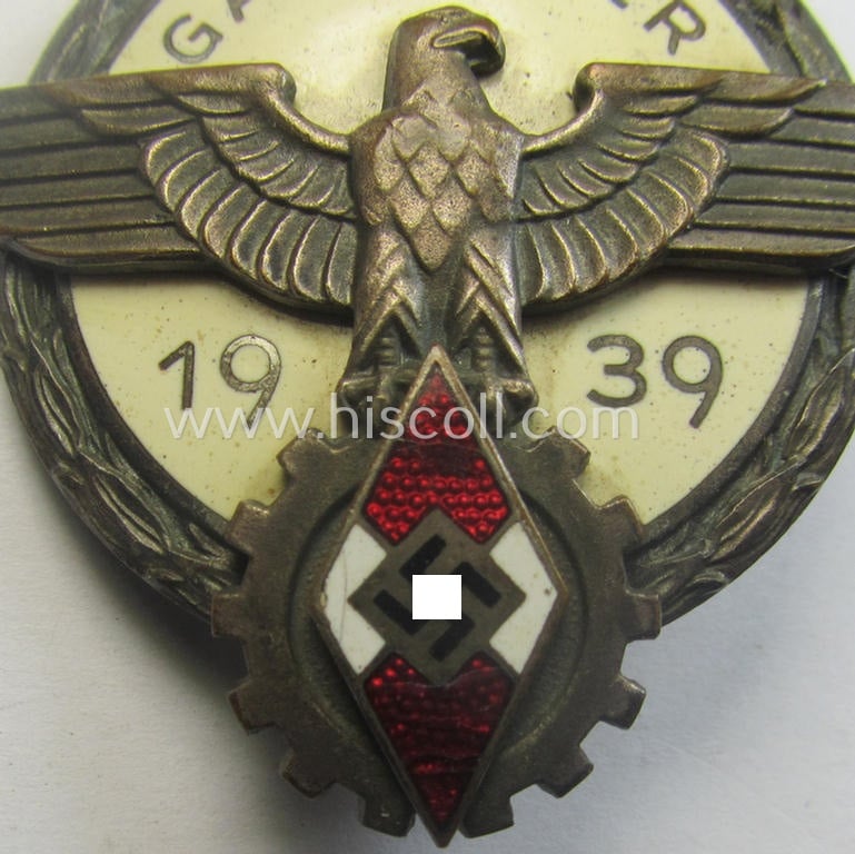 'Buntmetall'-based, 'HJ'- (ie. 'BDM'-) related so-called: 'Reichsberufswettkampf-Siegerabzeichen' (of the 2nd model) entitled: 'Gausieger 1939' and being a neatly maker- (ie.: 'G. Brehmer'-) marked example