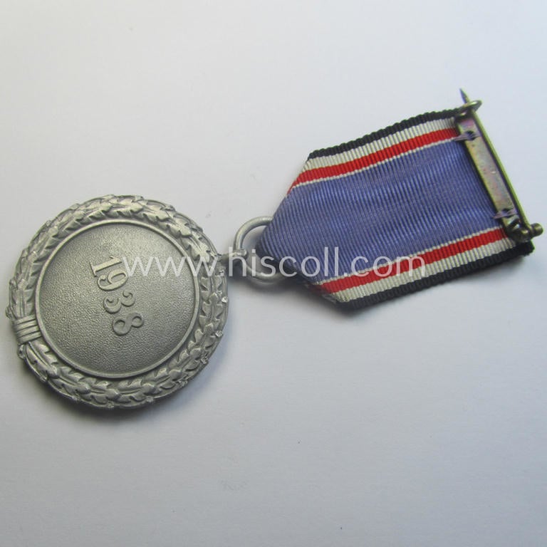 'Luftschutz-Ehrenzeichen 2. Stufe' being a non-maker-marked example as executed in (light-weight) aluminium-based metal and that comes mounted onto its period (confectioned) ribbon ie. 'Bandabschnitt'