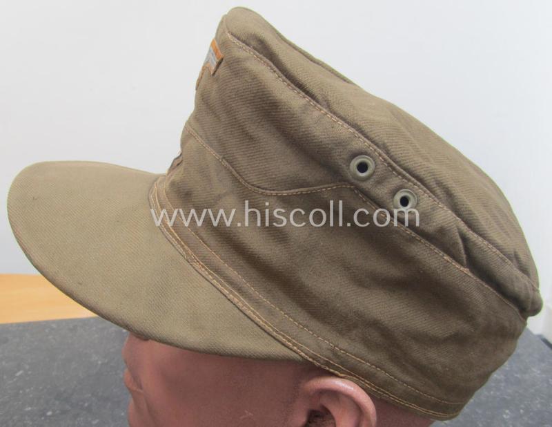 WH (Heeres), 'M41-pattern', tropical-issued field-cap (ie.: 'Tropen-Einheitsfeldmütze') being an (approx.) 57-cms.-sized example that is totally void of a makers'-, date- nor size-designation and that comes in a moderately worn- ie. used, condit...