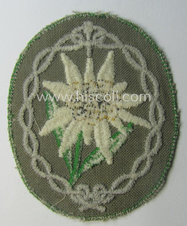 'Variant'-pattern WH (Heeres) 'Gebirgsjäger'- (ie. mountain-troopers-) related arm-badge, being a desirable example as was executed in the machine-woven pattern on thin-shaped (and bright-green rimmed) background