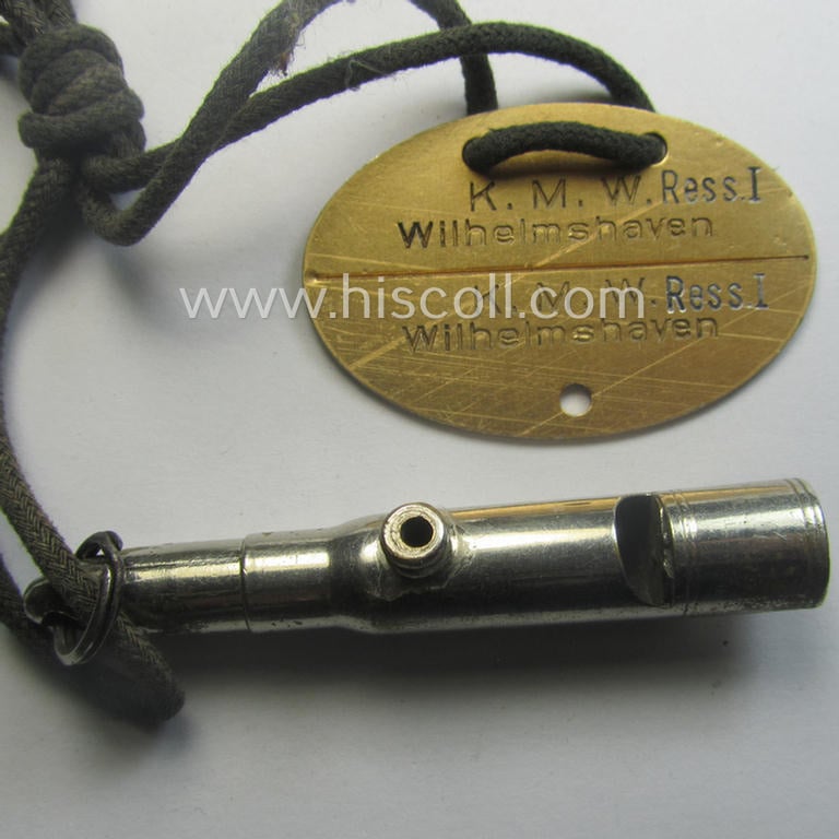 'Standard-issue'-pattern, WH (KM) typical aluminium-based- and/or bright golden-toned ID-disc (ie. 'Erkennungsmarke'): 'K.M.W. Ress. I - Wihelmshaven -  Heinen - 2895 - 79' and accompanying 'Bootsmanns-Flöte'
