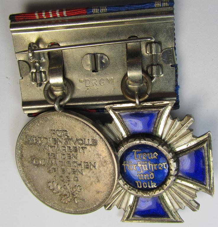 Superb, two-pieced medal-bar (ie. 'Ordenspange') showing resp. an: 'N.S.D.A.P. D.A. in Silber' (ie. '2. Stufe für 15 Jahre t. D.') and a: 'Deutsche Olympia-Erinnerungsmedaille 1936' that both come mounted as a (detachable!) 'Doppelspange'