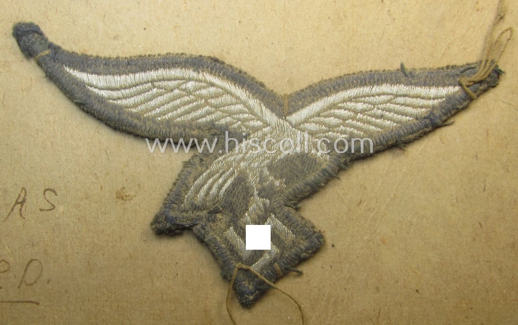 Interesting, WH (Luftwaffe) officers'- (ie. evt. NCO-) type breasteagle (ie. 'Brustadler') as was executed in neatly machine-woven silver-coloured thread (ie. 'flatwire-style') and that comes as GI-sent-back 'Christmas-souvenir'