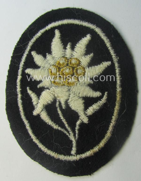 Waffen-SS-pattern, black-coloured sleeve-insignia (ie. 'Ärmelabzeichen') depicting an: 'Edelweiss'-flower as used by the various 'Gebirgsjäger'- (ie. mountain-troops-) related divisional-staff