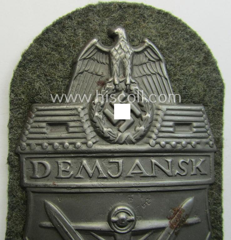 Superb example of a - fairly scarcely encountered! - WH (Heeres ie. Waffen-SS) 'Demjansk'-campaign-shield as executed in typical magnetic, so-called: 'Eisenblech' (and being of the 'missing-log' variant-pattern)