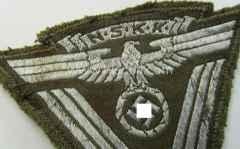 Attractive, so-called: N.S.K.K. (ie. 'National Socialistisches Kraftfahr Korps') arm-eagle (showing a combined arm-eagle and/or chevron) as executed in so-called: flatwire, 'BeVo'-weave pattern and comes mounted onto a beige-coloured background