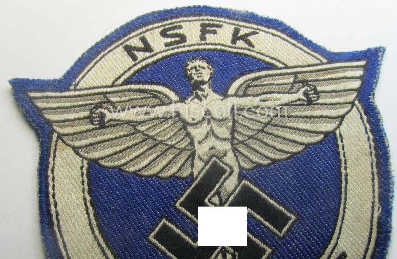 Very unusual, darker-blue-coloured: N.S.F.K.- (or: 'National Socialistisches Flieger Korps') sports-shirt breast-eagle for 'förderende Mitglieder' being a nicely 'BeVo'-woven- (and carefully 'cut-out'!) example