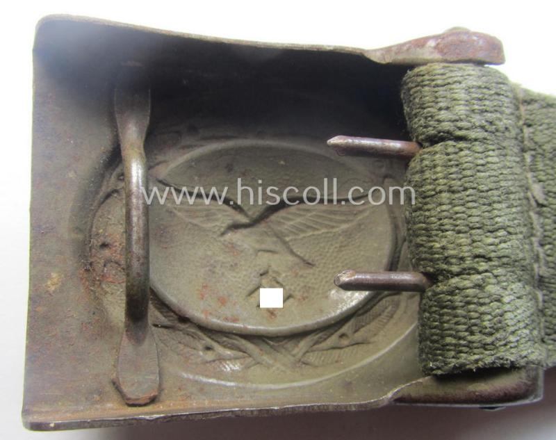 Rarely found WH (Luftwaffe) 'tropical-issued' belt-buckle being a non-maker-marked, beige-tan-coloured example that comes mounted onto its original, greenish-coloured- (and/or: 'webbing'-based-) tab