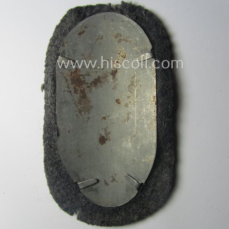 WH (Luftwaffe) 'Demjansk'-campaign-shield as executed in typical magnetic metal (ie. so-called: 'Eisenblech') and that comes in an overall nice- (ie. most certainly worn but nevertheless ie. fully untouched!), condition