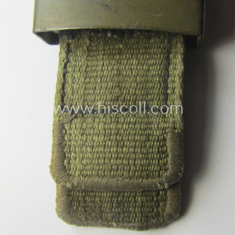 WH (Heeres) 'tropical-issued' belt-buckle being a non-maker-marked, field-grey-coloured example that comes mounted onto its original, greenish-coloured- (and/or: 'webbing'-based-) tab