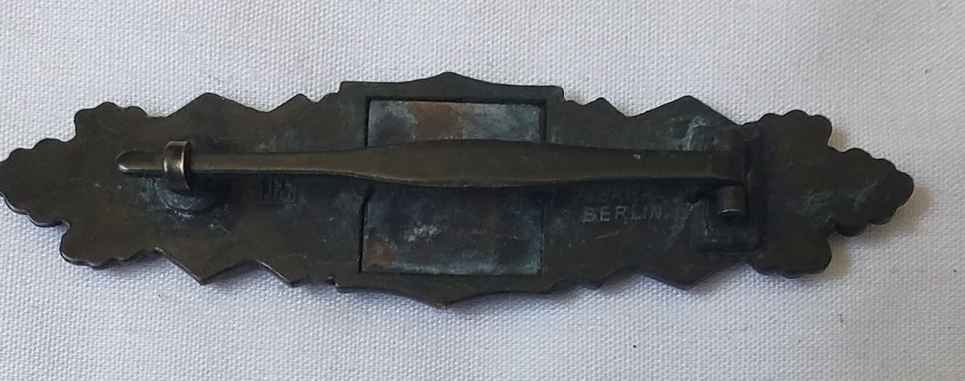 Reproduction 'Nahkampfspange in Bronze' (bronze class close combat clasp ie. CCC) being maker marked (ie 'JFS')