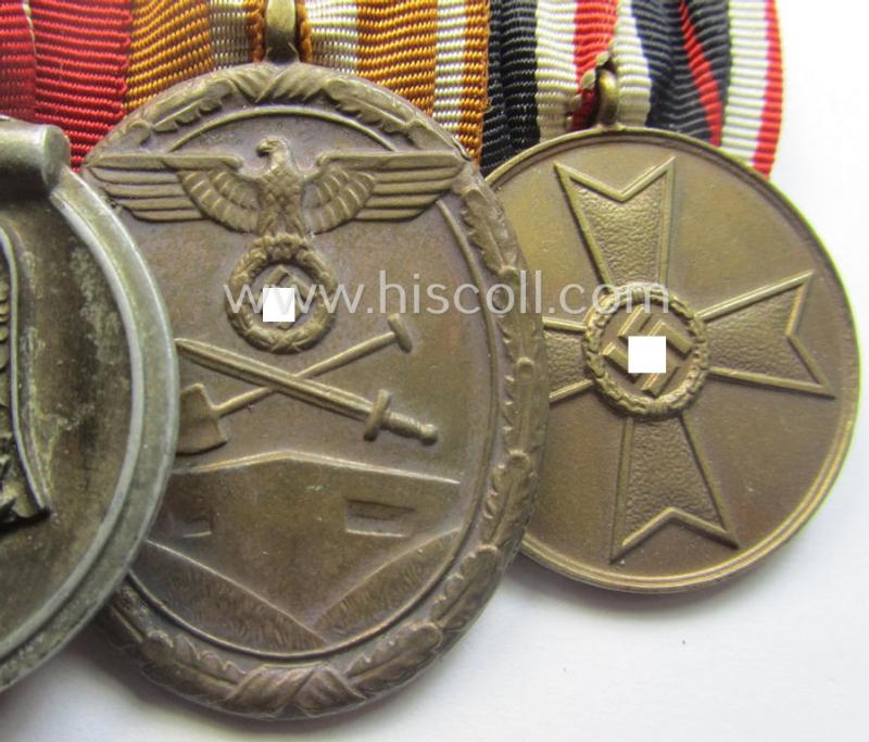 4-pieced, WWII-period medal-bar (ie. 'Ordenspange') showing resp. an: 'EKII.Kl.', a: 'Medaille Winterschlacht im Osten 1941-42' a: 'KvKII.Kl. m. Schw.', a: 'Westwall'-medal and 'Kriegsverdienstmed. 1939'