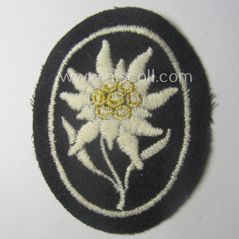 Waffen-SS-pattern, black-coloured sleeve-insignia (ie. 'Ärmelabzeichen') depicting an: 'Edelweiss'-flower as used by the various 'Gebirgsjäger'- (ie. mountain-troops-) related divisional-staff