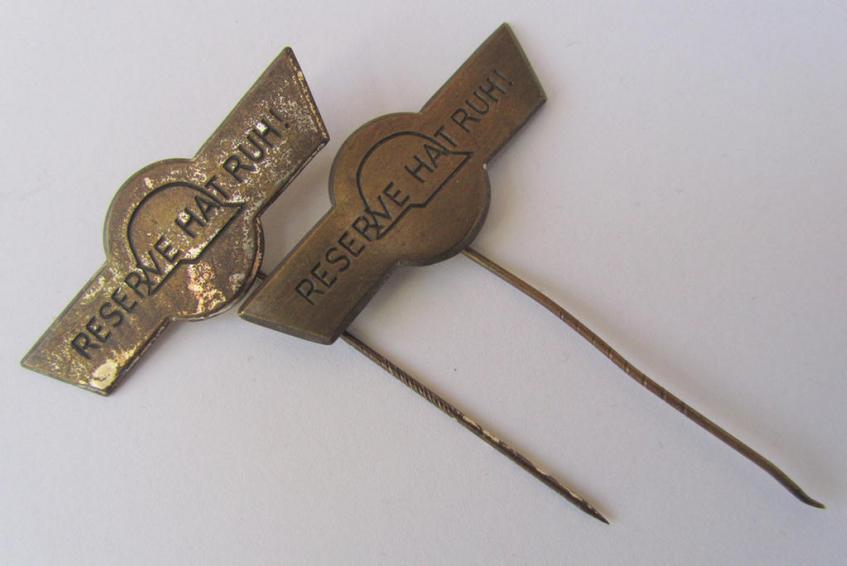 Two-pieced lapel-pin-set comprising of two, tin-based pins (ie. 'Steckabzeichen') both showing the text: 'Reserve hat ruh!', depicting that the bearer was a veteran ie. 'Reservist'