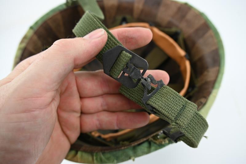 US Vietnam War Infantry helmet with camouflage cover and attached content