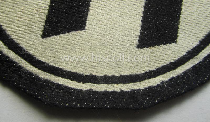 Waffen-SS sport-shirt emblem as executed in the neat 'BeVo'-weave pattern that still retains its period-attached 'RzM'-etiket and that comes in an overall very nice- (ie. 'virtually mint'-), condition