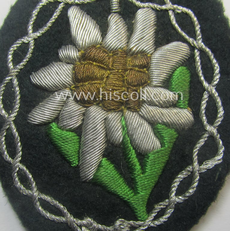 Superb - and just moderately used! - WH (Heeres) neatly hand-embroidered- and/or typical officers'- (ie. 'variant'-) pattern so-called: 'Edelweiss'-arm-badge (as specifically intended for usage by an officer serving within the 'Geb.-Jäger-Trpn.')