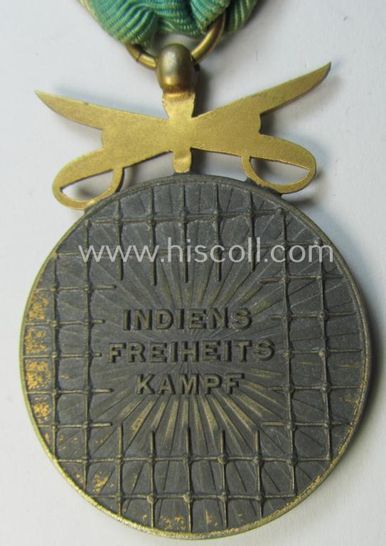 Attractive, WH-related so-called: 'Azad Hind - Goldene Tapferkeits-Medaille mit Schwerten' (being a typical non-maker-marked- and/or: 'Feinzink'-based example that comes mounted onto its period ribbon)
