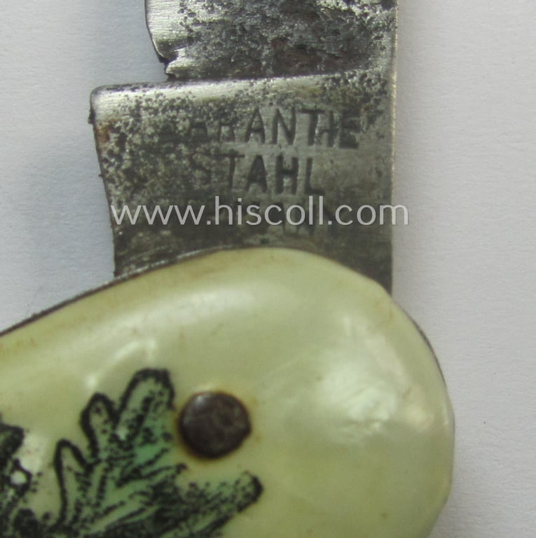 Interesting, (pre-) WWII-period 'souvenir-item' (ie. tiny pocket-knife) showing on its front an illustration of a soldier wearing a steel-helmet flanked by oakleaves coupled with the text: '1938 - 1939 - Westwall - Westfront'