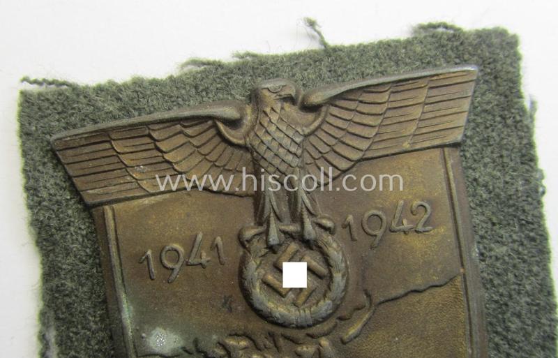 Attractive, WH (Heeres o. Waffen-SS) 'Krim'-campaign-shield that comes mounted onto its original, field-grey-coloured 'backing' and that comes in a surely issued-, minimally worn and/or (I deem) carefully tunic-removed-, condition