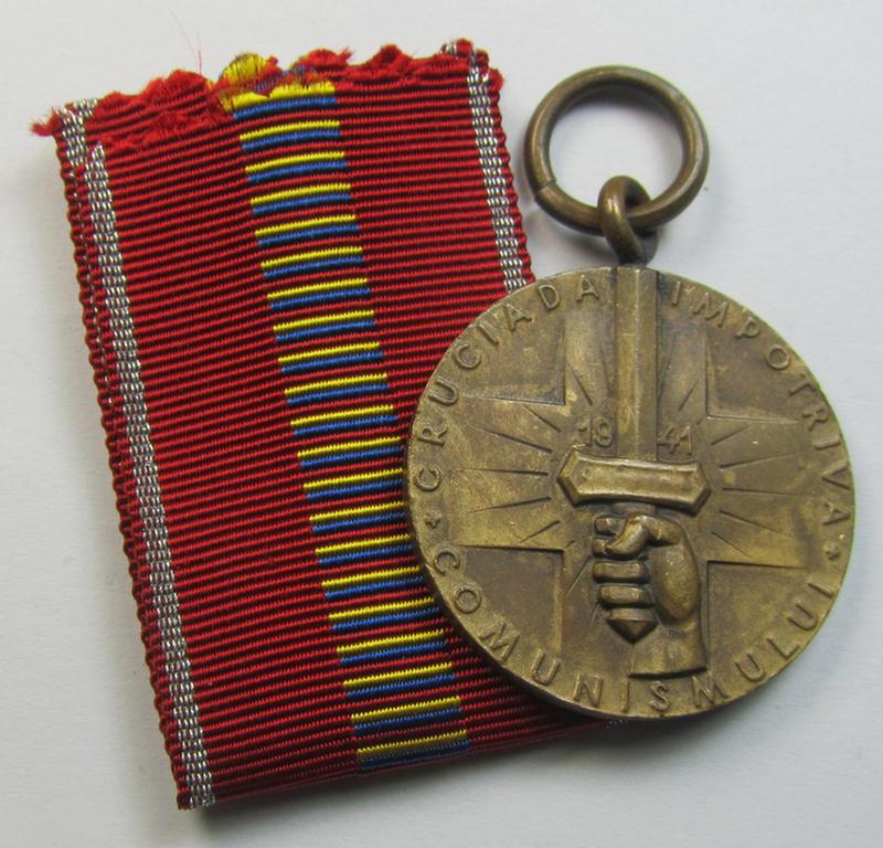 Romanian medal: 'Kreuzzug gegen den Kommunismus' (or in Romanian language: 'Medalia - Crusiada Impotriva Communismului') that comes together with its original (and never confectioned- ie. 'virtually mint') ribbon as issued