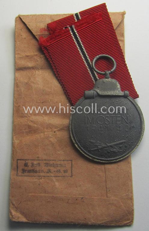 Neatly maker- (ie. '19'-) marked medal: 'Winterschlacht im Osten 1941/42' that came stored in its period pouch by the company: 'E. Ferd. Wiedmann'