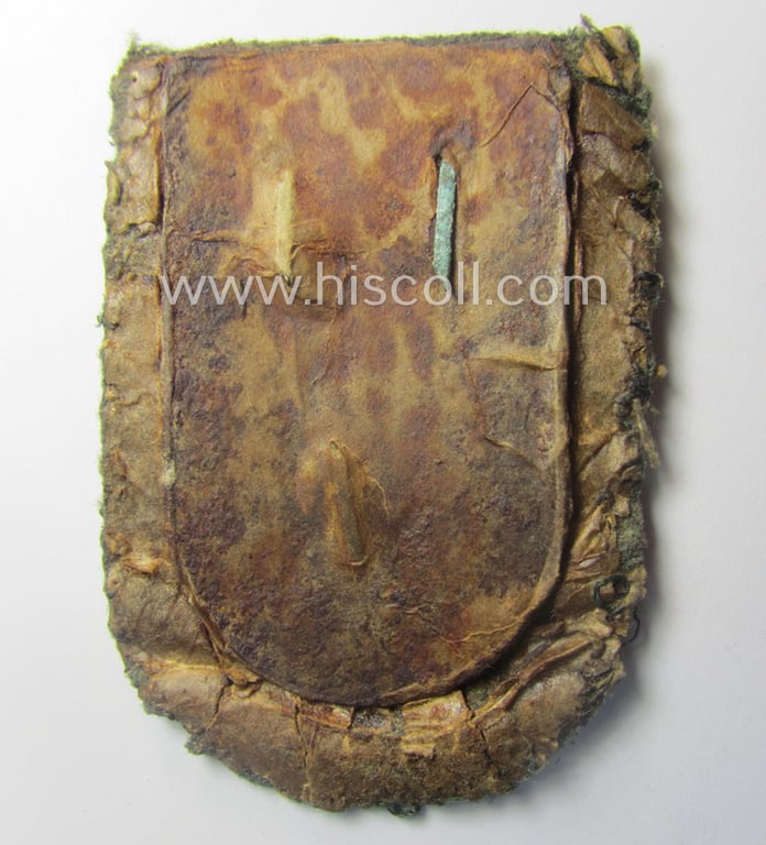 Stunning - and truly rarely encountered! - WH (Heeres ie. Waffen-SS) so-called: 'Cholm'-campaign-shield as executed in magnetic, so-called: 'Eisenblech' being a 'Long M-variant-pattern' shield that comes in a moderately used- ie. worn-, condition