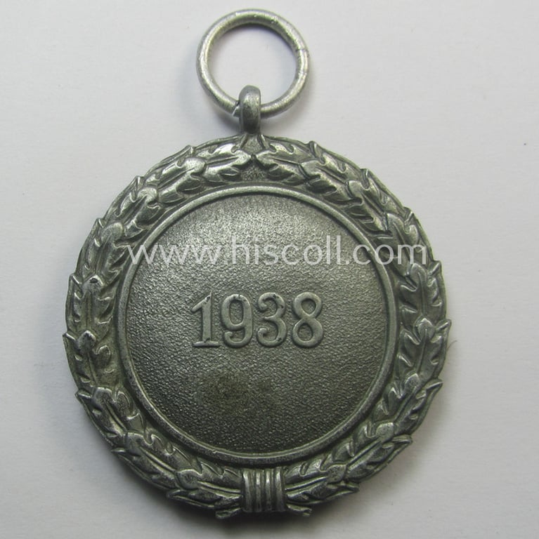 'Luftschutz-Ehrenzeichen 2. Stufe' being a maker- (ie. '10'-) marked example, as executed in (heavy) zinc-based metal (ie. 'Feinzink') and that came together with its period ribbon (ie. 'Bandabschnitt')