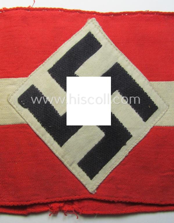 'Standard-issued'-pattern (ie. entirely woven) pattern, bright-red-coloured HJ- (ie. 'Hitlerjugend'-) related armband (ie. 'Armbinde') being a moderately worn- ie. used example that misses its 'RzM'-etiket