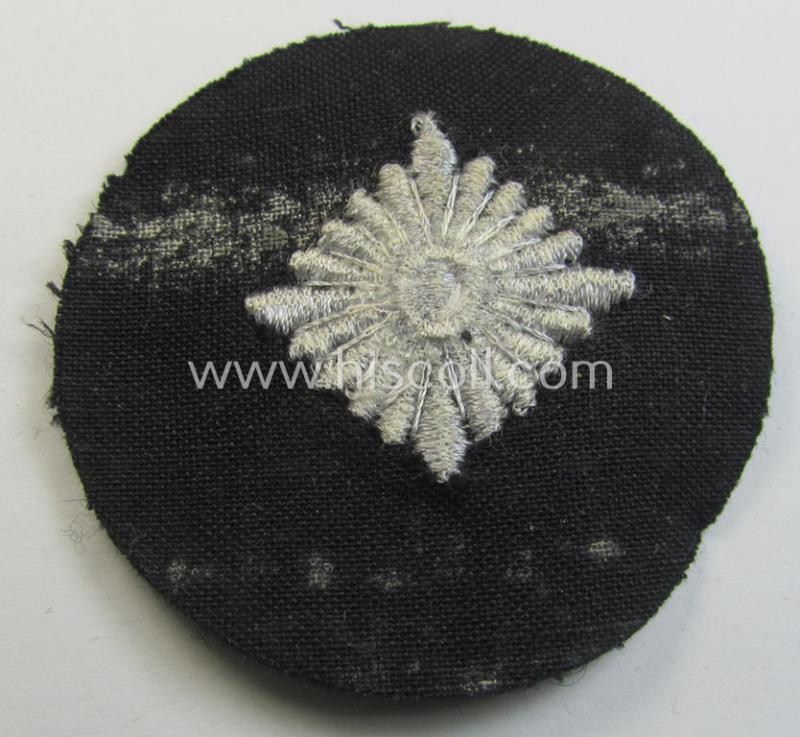 WH (Heeres) rank-insignia (ie. silver-grey-coloured and machine-embroidered 'roundel') as intended to identify a soldier with the rank of: 'Oberschütze', 'Oberjäger' etc. that comes in a 'virtually mint- ie. unissued', condition