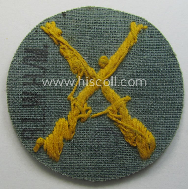 WH (Heeres) hand-embroidered, trade- ie. special-career arm-patch as was intended for a: 'Waffenmeister' (or: weapon-equipment NCO) being a maker-marked example as executed on darker-green-coloured wool