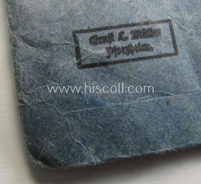 'Eisernes Kreuz 2. Kl.' being a maker- (ie. '76'-) marked example that comes stored in its period 'Zellstoff'-based pouch by the: 'Ernst L. Müller'-company as was based in the town of Pforzheim